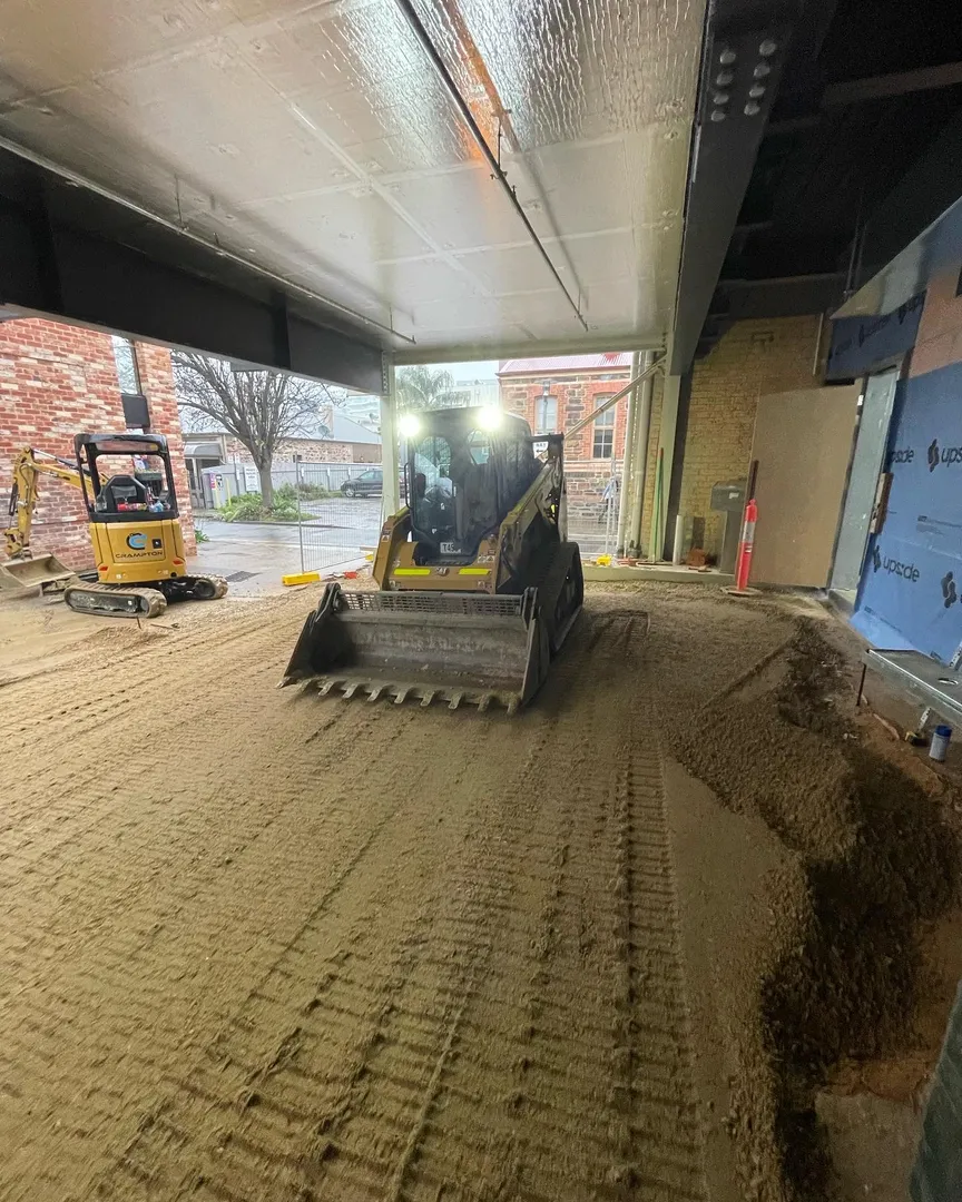 Small construction equipment leveling indoor dirt floor