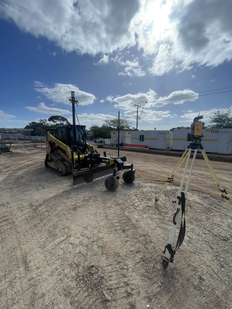 Bulldozer and survey device at construction site