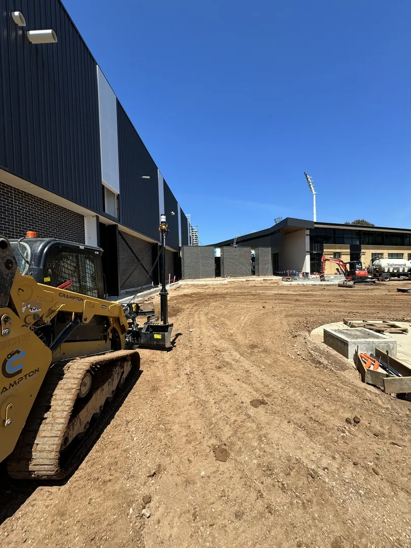 Construction site with machinery and buildings.