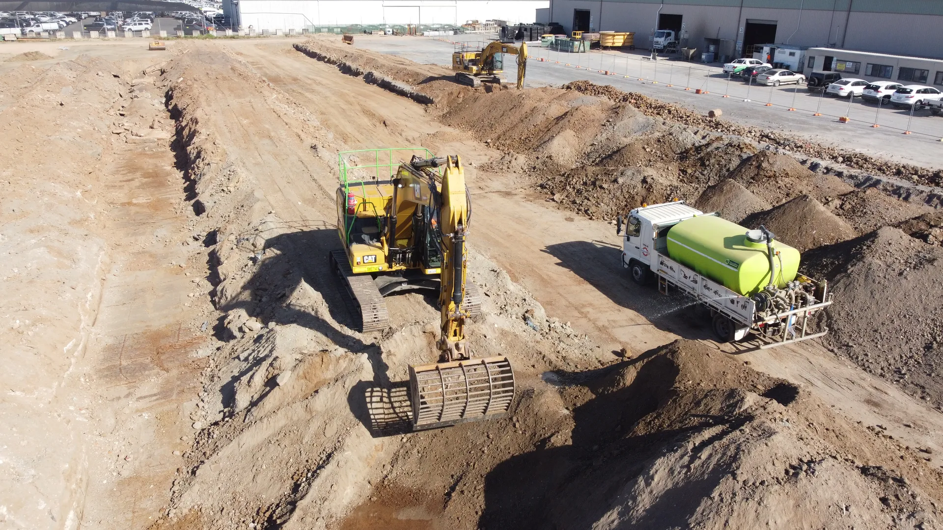 Construction site with excavator and water truck