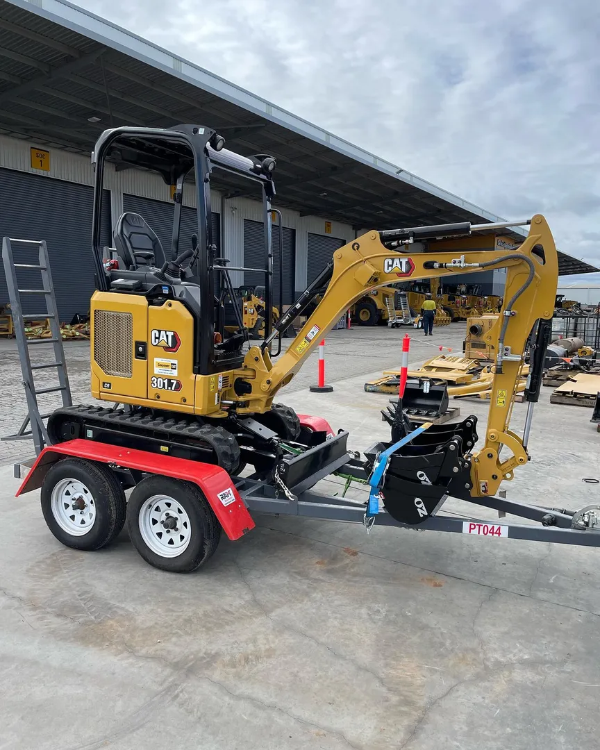 Cat mini excavator on a trailer